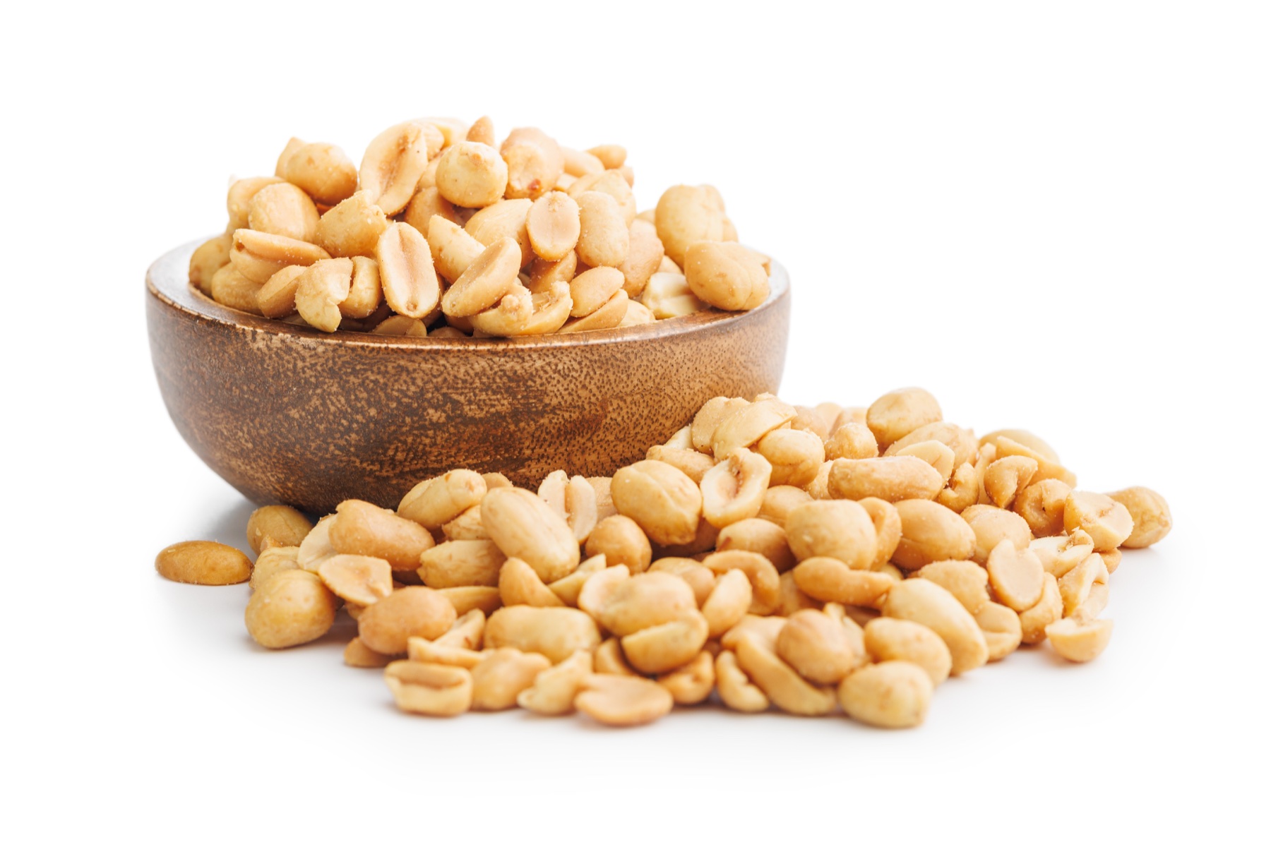 Roasted peanut kernels served in a wooden bowl